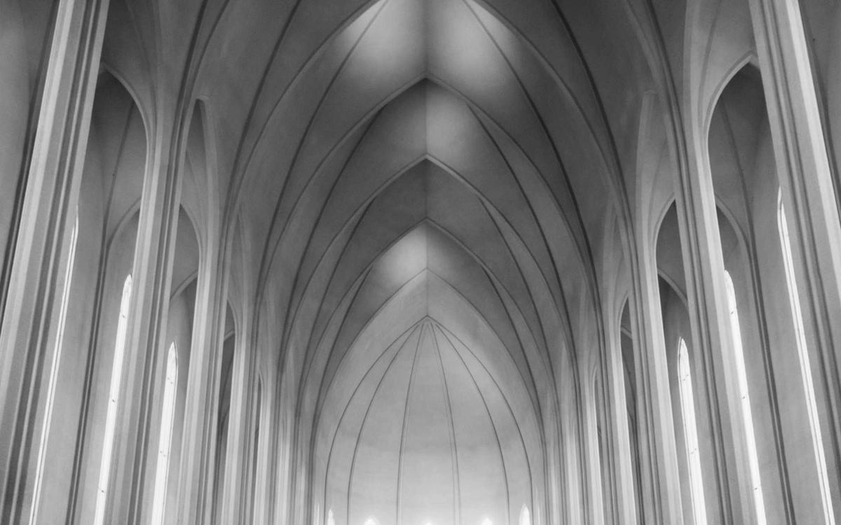Pale stone columns rising into pointed vaults